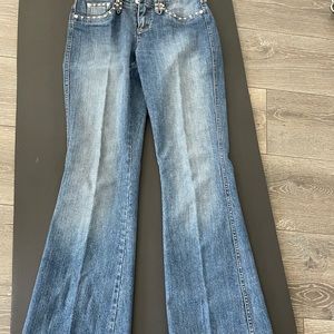 Cache jeans with rhinestones on pockets, belt loops and around back trim